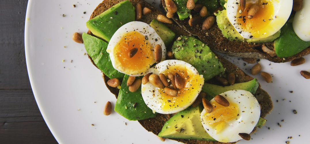 Boiled egg on toast with avocado.