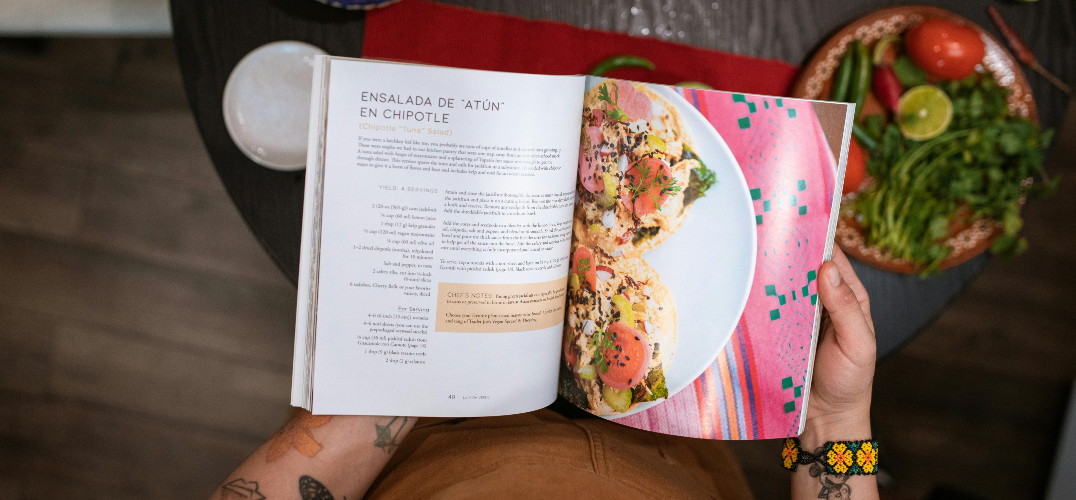 Person looking through a cookbook.